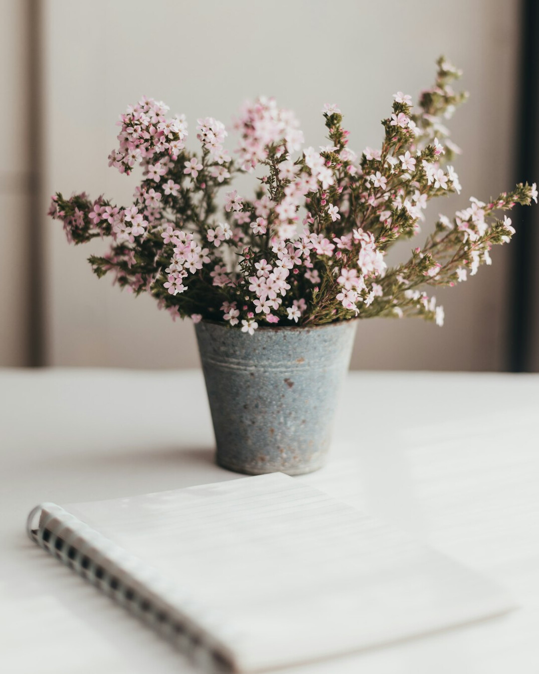 Notebook, pen and laptop on a creative desk